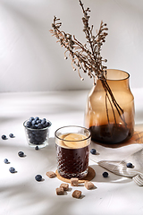 Image showing glass of coffee, brown sugar and blueberries