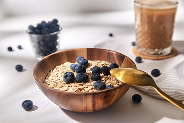 Image showing oatmeal with blueberries, spoon and coffee