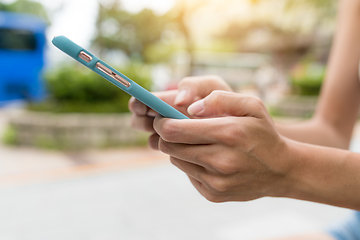 Image showing Using mobile phone in the street