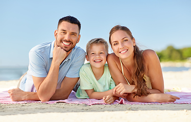 Image showing happy family lying on summer beach