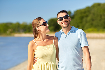 Image showing happy couple hugging on summer beach