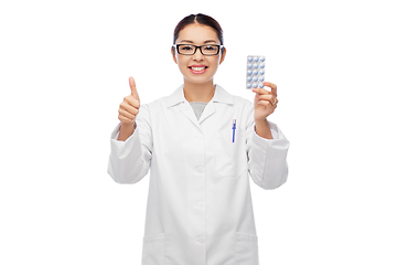 Image showing smiling asian female doctor or nurse with medicine