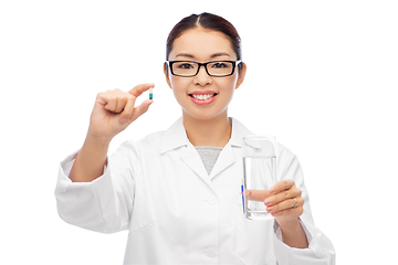 Image showing asian doctor with medicine and glass of water