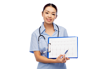 Image showing happy smiling asian female doctor with cardiogram