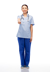 Image showing smiling asian female doctor or nurse in uniform