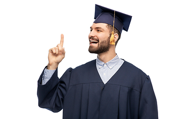 Image showing happy graduate student pointing his finger up