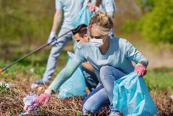 Image showing volunteers with garbage bags cleaning park area