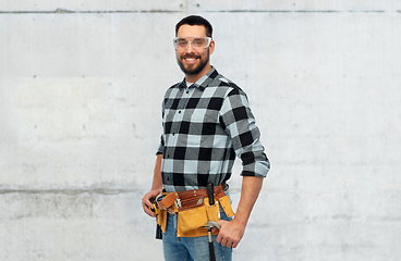 Image showing happy male worker or builder with tool belt