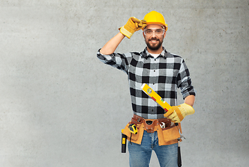 Image showing happy male worker or builder in helmet with level