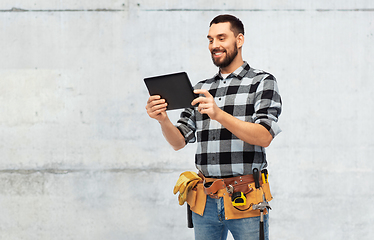 Image showing happy builder with tablet computer and tools