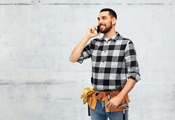 Image showing builder in helmet calling on smartphone