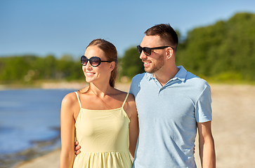 Image showing happy couple hugging on summer beach