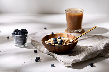 Image showing oatmeal with blueberries, spoon and coffee