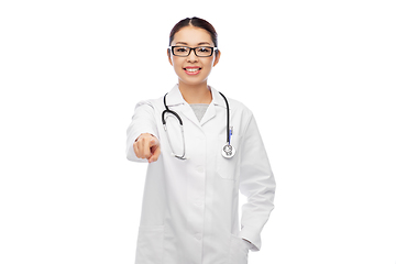 Image showing smiling asian female doctor pointing to you