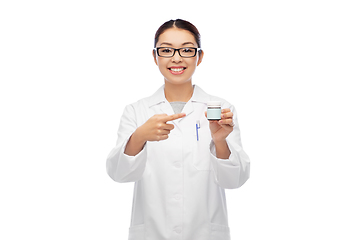 Image showing smiling asian female doctor or nurse with medicine