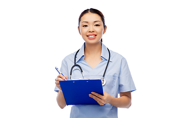 Image showing happy smiling asian female doctor with clipboard