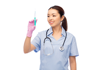 Image showing happy asian female nurse with medicine and syringe