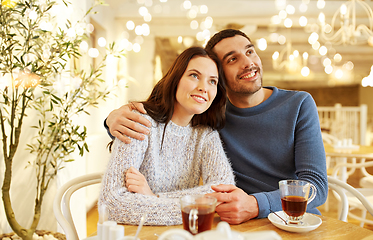 Image showing happy couple drinking tea at restaurant