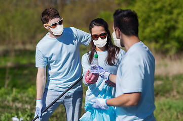 Image showing volunteers with garbage bags cleaning park area