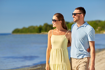 Image showing happy couple hugging on summer beach