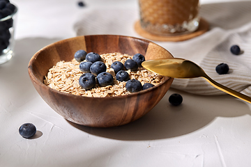 Image showing close up of oatmeal in bowl with blueberries