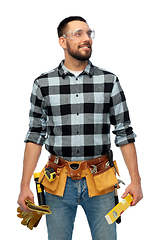 Image showing happy male worker or builder with tools and level