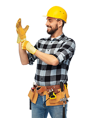 Image showing happy male worker or builder in helmet and gloves