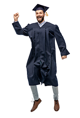 Image showing happy male indian graduate student jumping