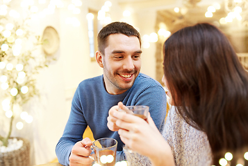 Image showing happy couple drinking tea at cafe