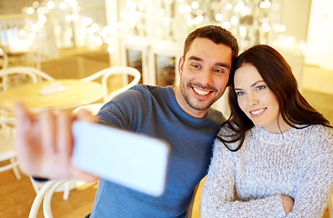 Image showing couple taking smartphone selfie at cafe restaurant
