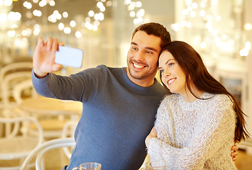 Image showing couple taking smartphone selfie at cafe restaurant