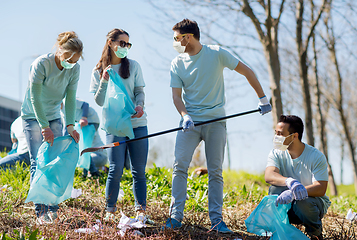 Image showing volunteers with garbage bags cleaning park area