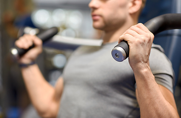 Image showing smiling man exercising in gym