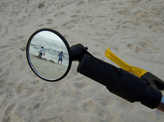 Image showing kids on the beach through the bike mirror