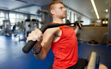 Image showing close up of man exercising on cable machine in gym