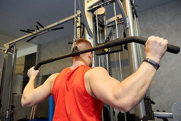 Image showing close up of man exercising on cable machine in gym