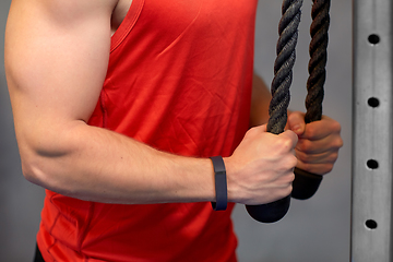 Image showing close up of man exercising on cable machine in gym