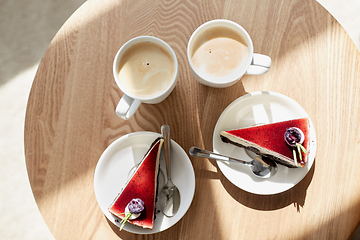 Image showing pieces of chocolate cake on wooden table