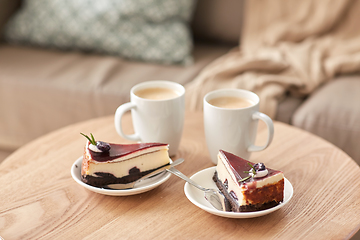 Image showing pieces of chocolate cake on wooden table