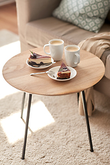 Image showing pieces of chocolate cake on wooden table