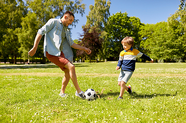 Image showing father with little son playing soccer at park