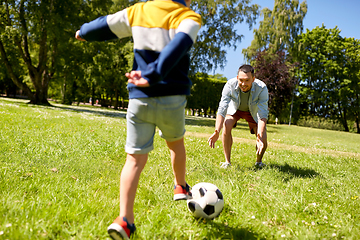 Image showing father with little son playing soccer at park