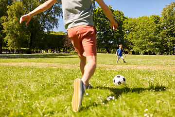 Image showing father with little son playing soccer at park