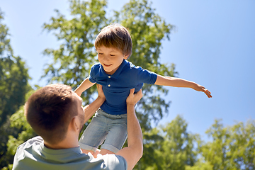 Image showing happy father with son playing in summer park