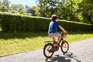 Image showing little boy riding bicycle at summer park