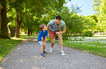 Image showing happy father and son compete in running at park