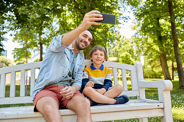Image showing father and son taking selfie with phone at park