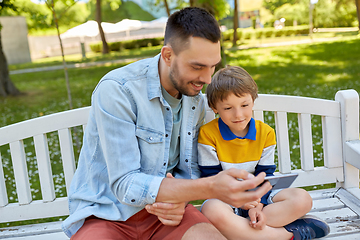 Image showing father and son with smartphone at park