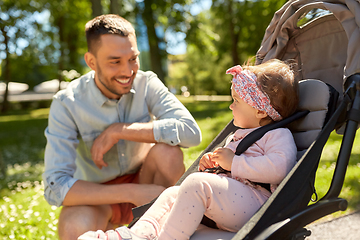 Image showing happy father with child in stroller at summer park