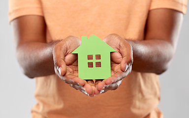 Image showing close up of african man holding green house